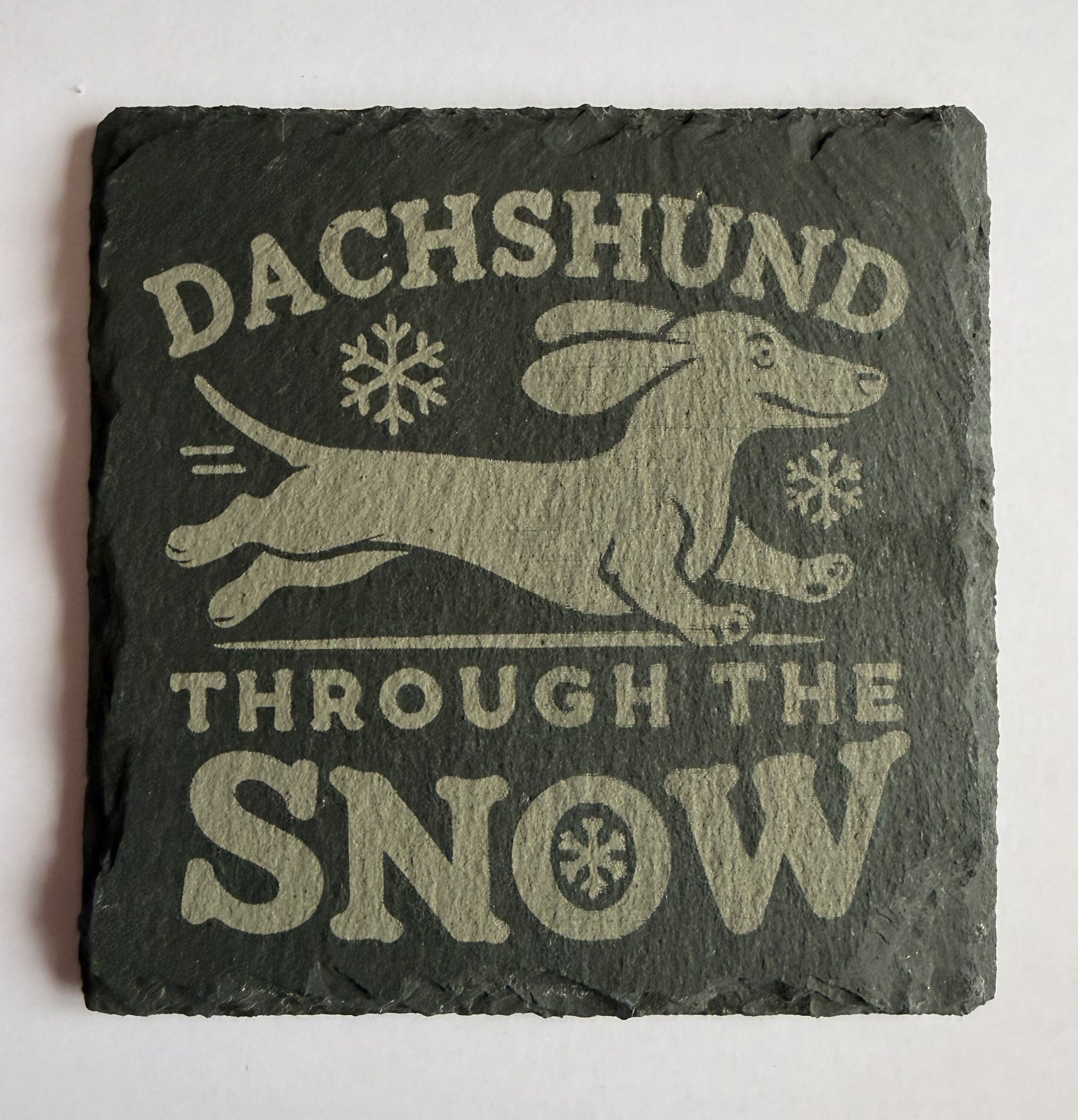 Dachshund Through the Snow laser engraved slate coaster with snowflakes