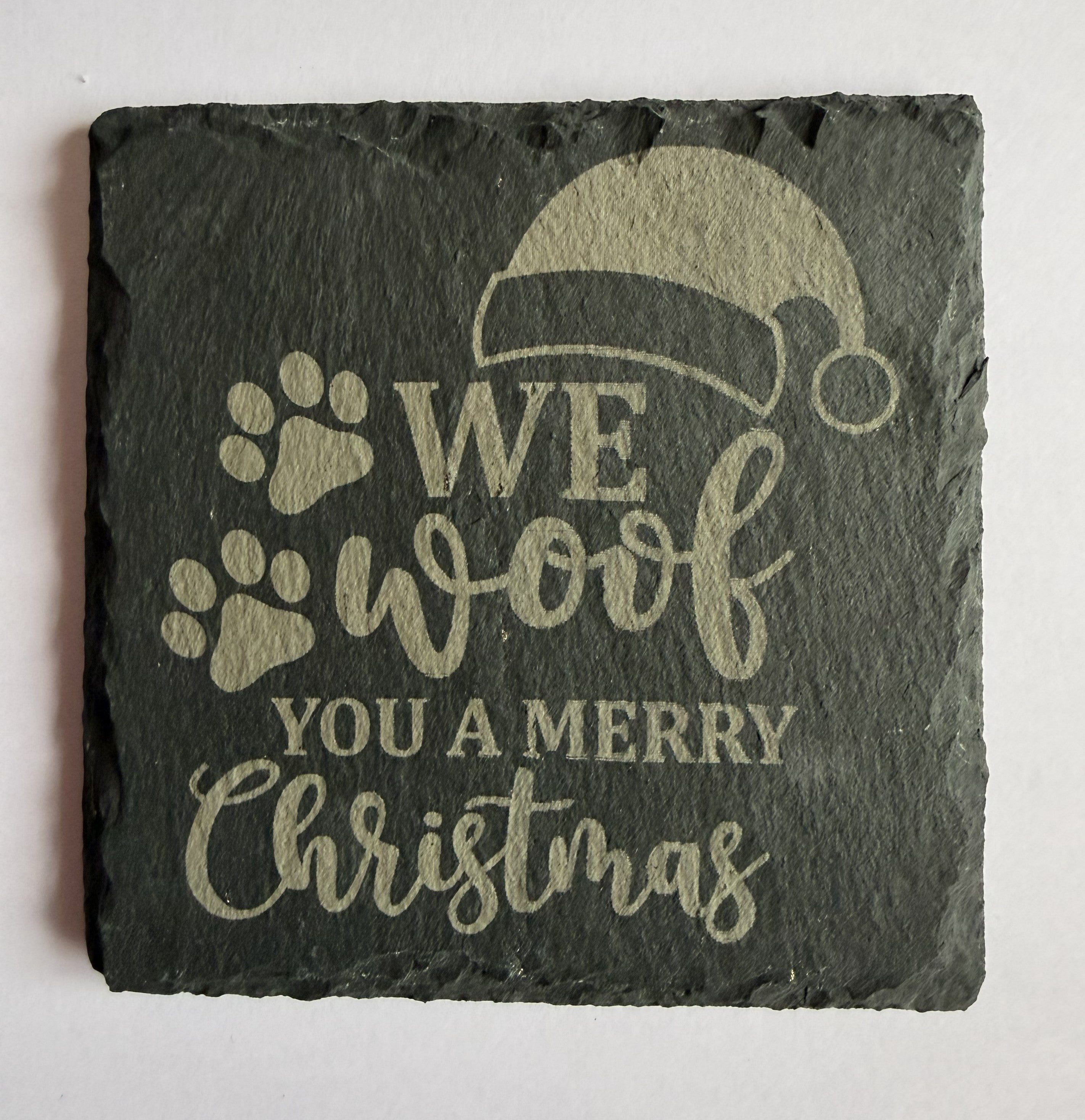 We Woof You a Merry Christmas laser engraved slate coaster with paw prints and Santa hat