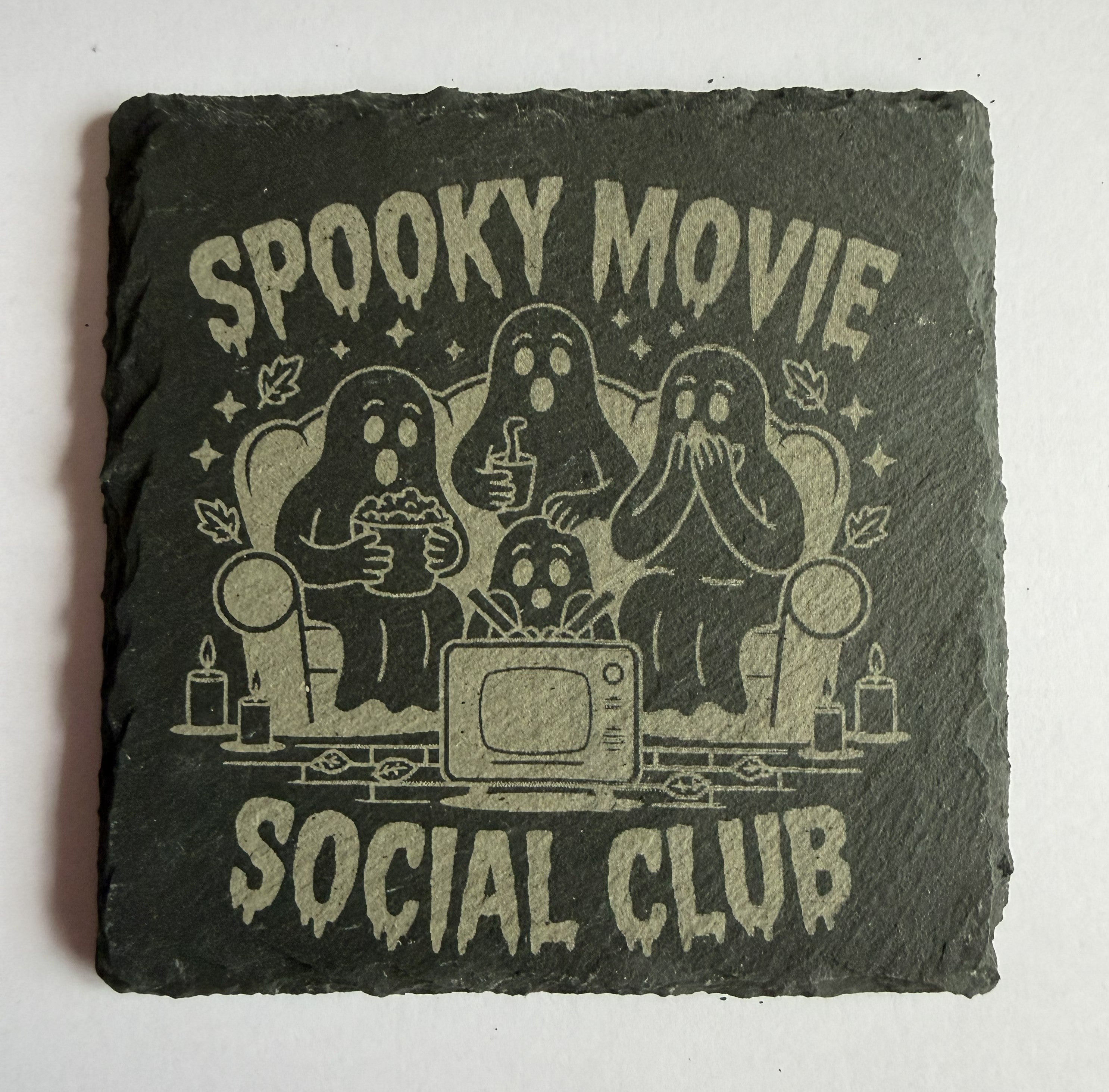 Spooky Movie Social Club laser engraved slate coaster with ghosts watching TV